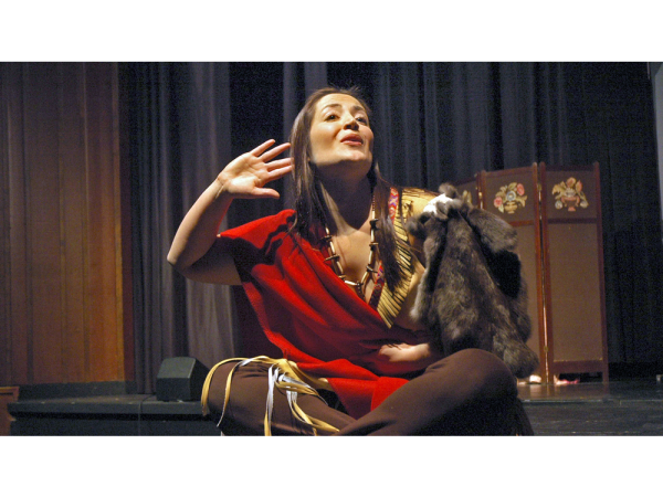 Paddle Song seated lady listening with her hand behind her ear