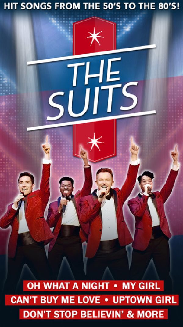 Four men in red suits with their hands in the air.