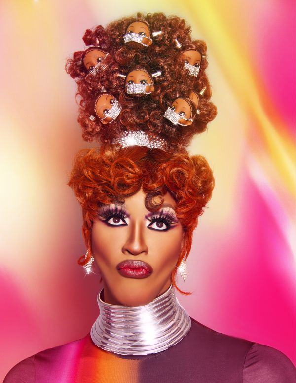 Tynomi Banks by Quinton Cruickshanks drag queen with a beehive hair style that includes doll heads with masks
