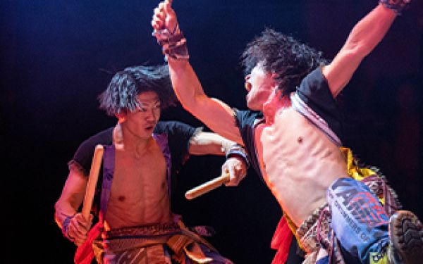 two drummers mid-swing
