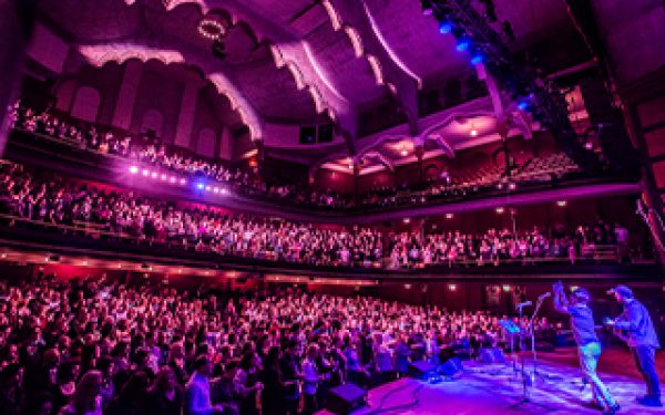 the group on stage to a sold out audience