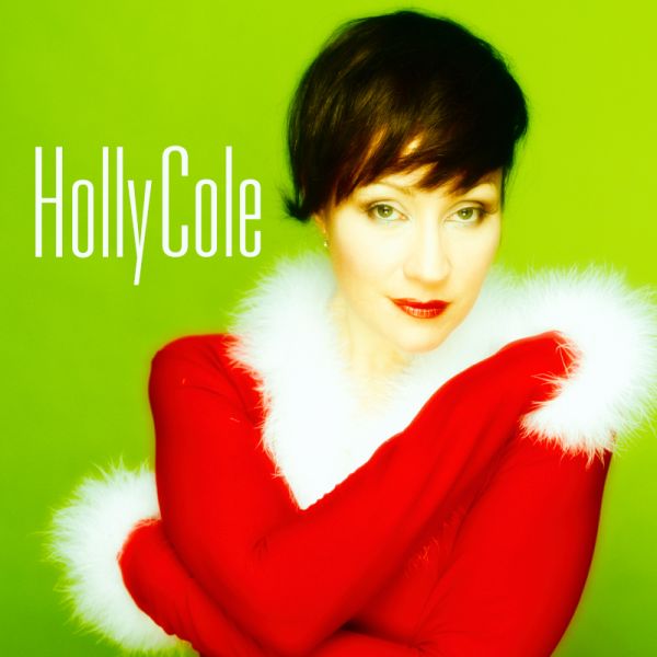 Holly Cole - A Swinging Christmas Holly in a red santa shirt with white fur trim on neck and wrists